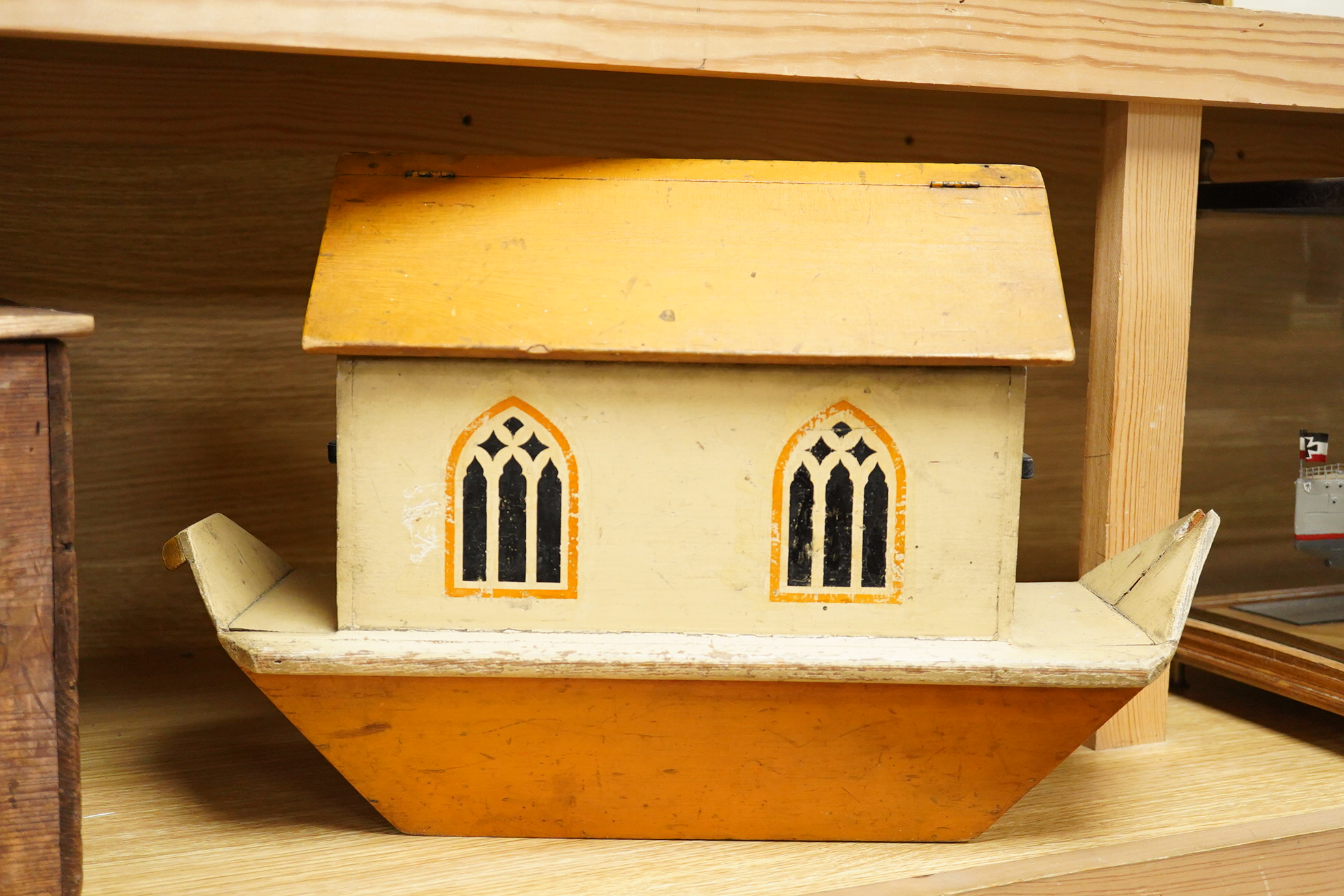 A First World War ‘War Relief Toy Work’ painted pine Noah's Ark with a quantity of carved and painted wooden animals, the ark with hinged lid, label pasted to the inside of the lid stating; Made in England, with a biblic